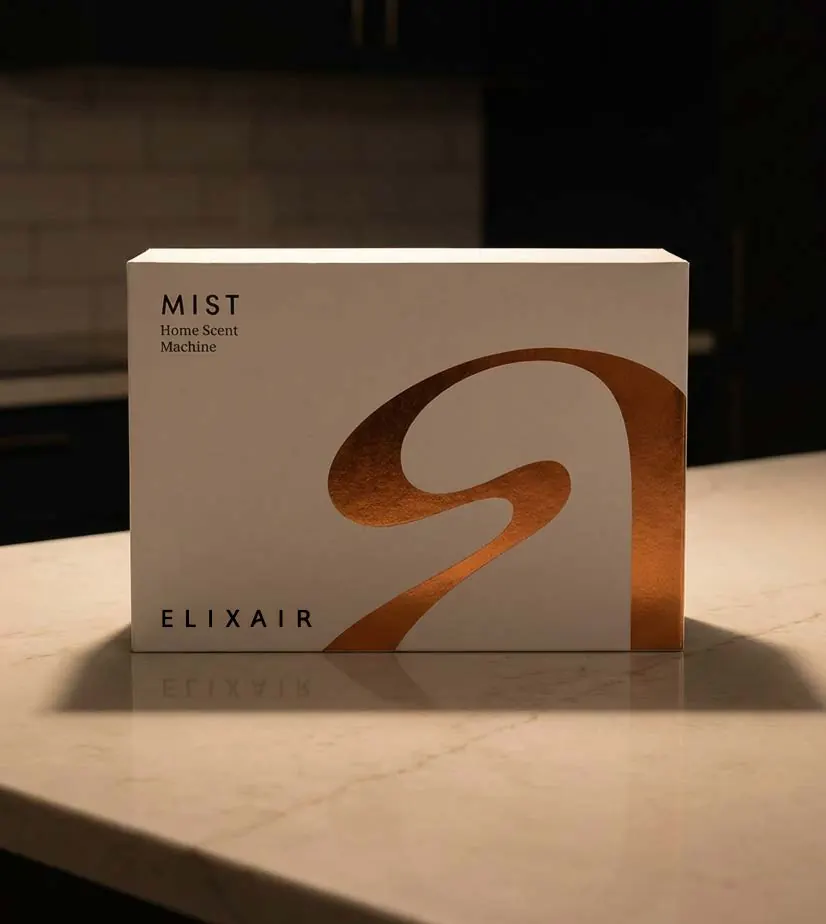 The MIST box, white with a sweeping copper monogram, on a marble kitchen island